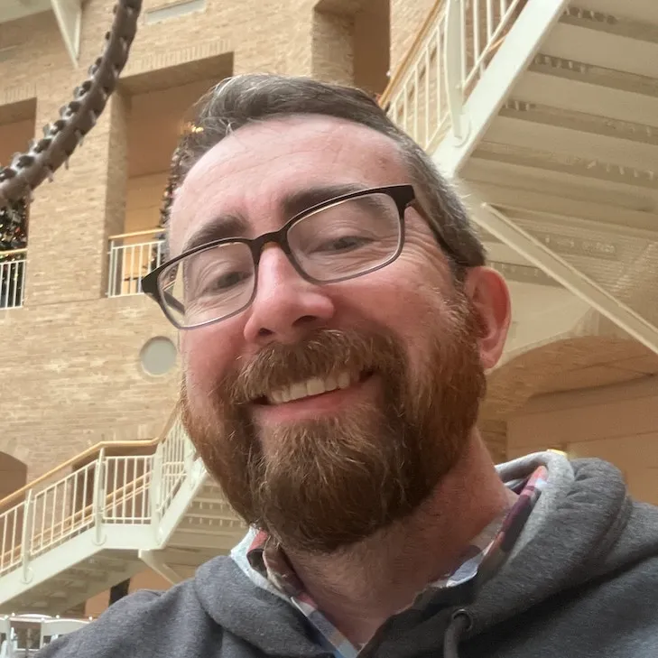 Photo of Patrick Doran. He's a web developer and designer. In this photo he is wearing glasses and smiling. Photo credit to my selfie-length arm.